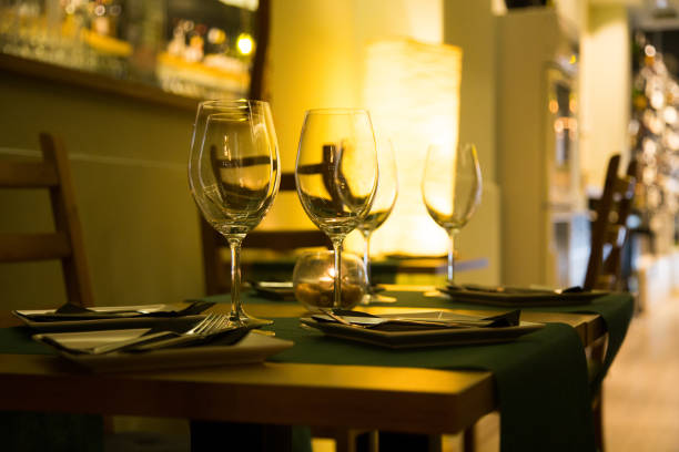 istock Elegant restaurant table with cutlery, crockery and glasses. 1460971005
