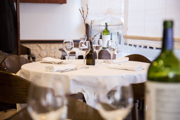 istock Elegant restaurant table with cutlery, crockery and glasses. 1460971888