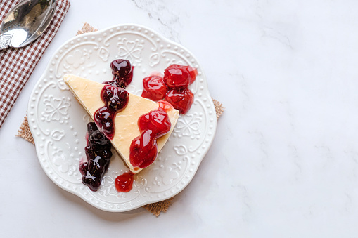 Blurberry and Rasberry Cheesecake, beautifully decorated, on a white plate, Dessert concept, Valentine's day