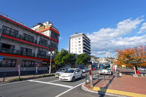 street scene at a road junction in atami city, shizuoka, japan. - tranquil scene sky street road imagens e fotografias de stock