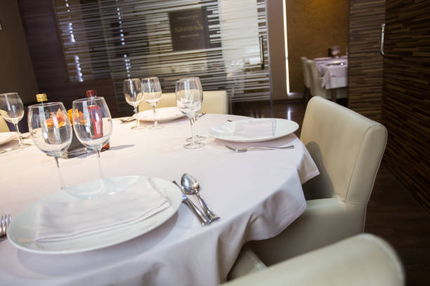 istock Elegant restaurant table with cutlery, crockery and glasses. 1460972425