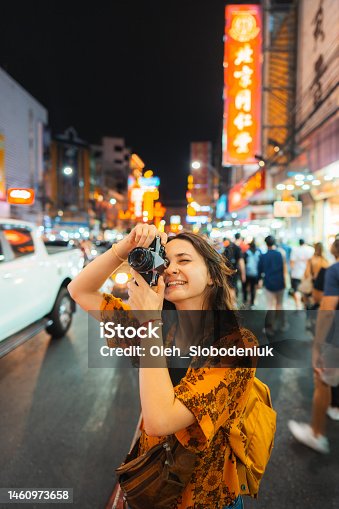istock Woman photographing with camera in Chinatown, Bangkok 1460973658