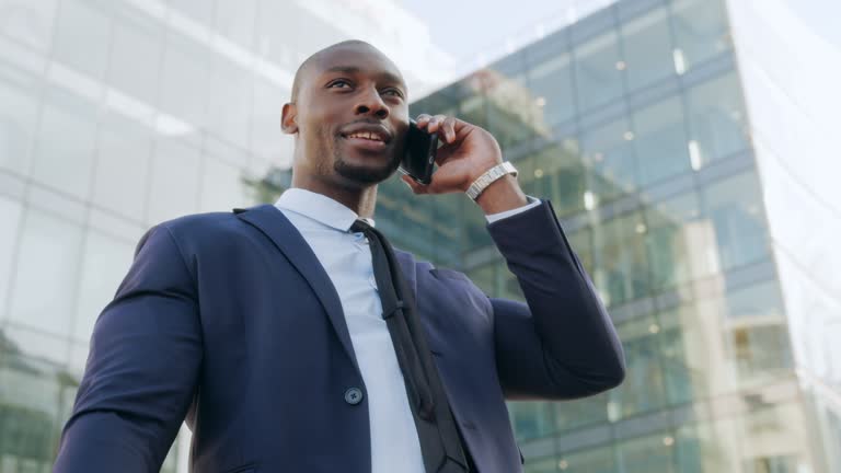 Phone. Man talking on mobile phone in city business district