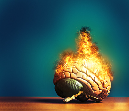 Human brain bursts into fire and flames, with copy space to the left.