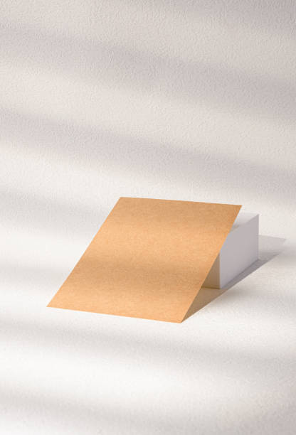 istock mockup blank kraft business card on white block with sunlight 1460978129