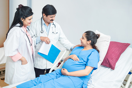 Young Indian pregnant woman visiting doctor at the hospital, Pregnancy Checkup.