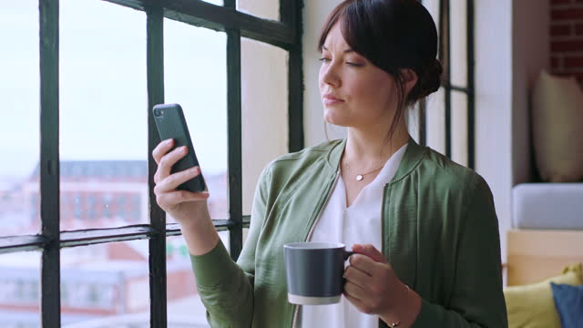 Phone, coffee and business woman in office on social media, texting or internet browsing. Tea, mobile and female employee from Canada networking on smartphone, web scrolling or messaging by window.