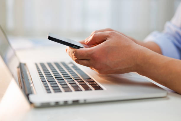 Close up of a businessman using smart phone in the office