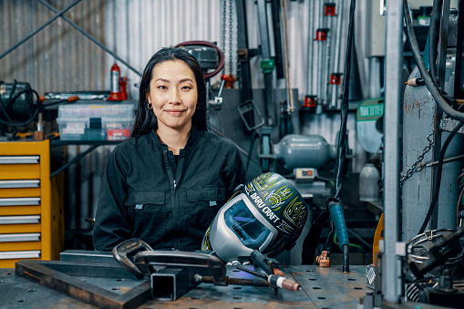 Portrait of a mid adult female welder in a metal fabrication factory