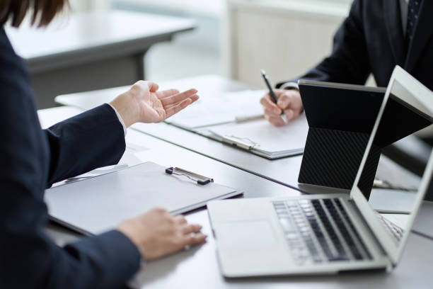 Asian business people having a meeting in a conference room Asian business people having a meeting in a conference room talking two people business talk business stock pictures, royalty-free photos & images