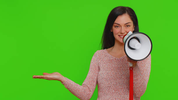 istock Woman talking with megaphone, proclaiming news, loudly announcing advertisement pointing empty place 1460980745