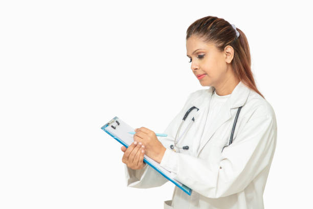 beautiful indian female doctor with stethoscope standing with notepad prescribes medicine, healthcare and medical concept. - cheerful doctor prescribes professional occupation imagens e fotografias de stock