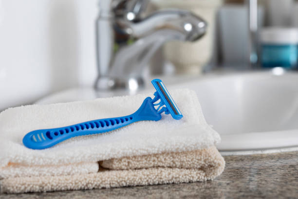 Blue razor and handkerchief on white basin