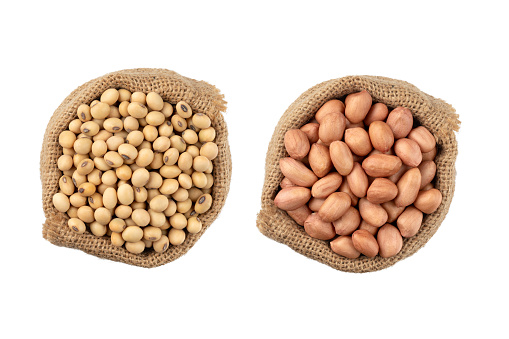 soybean seeds and Peanut in a sack on white background, top view