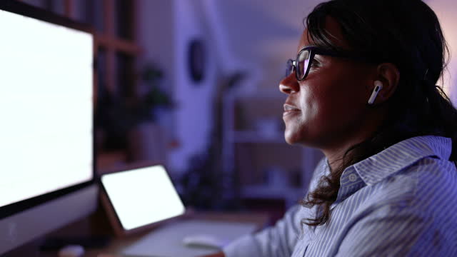 Mid adult architect woman working late at night in her office