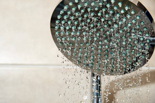 istock Closeup view of shower head with streaming water drops 1460985713