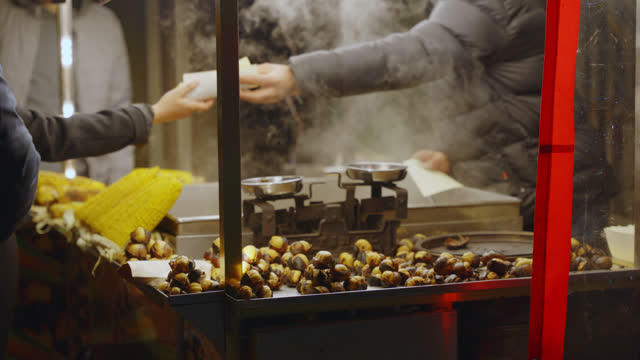 SLO MO Selling grilled corn at a local market at night