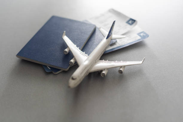 istock Passports, boarding passes and toy airplane on white table 1460986718