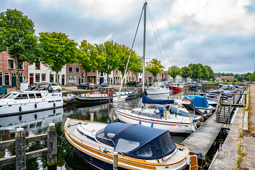 Old houseboats in the historic harbor of the old fortified town of Woudrichem.