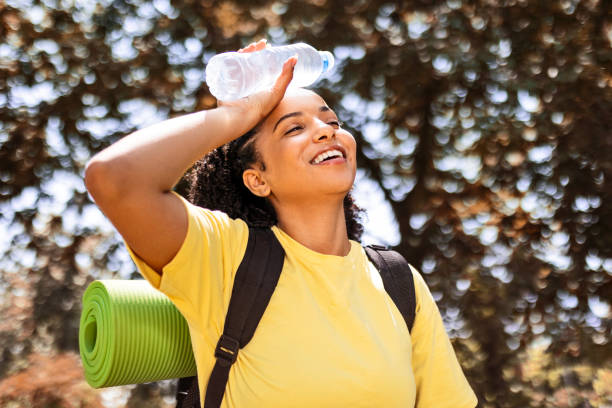 istock Young woman hiking on hot day 1460994991