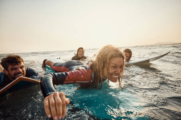 istock Cheerful surfers having fun in summer day at sea. 1460995865