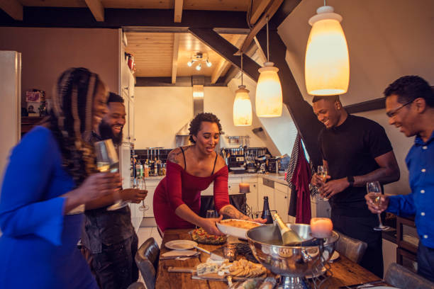 istock Black woman setting the table at a dinner party celebration for her guests 1460997183