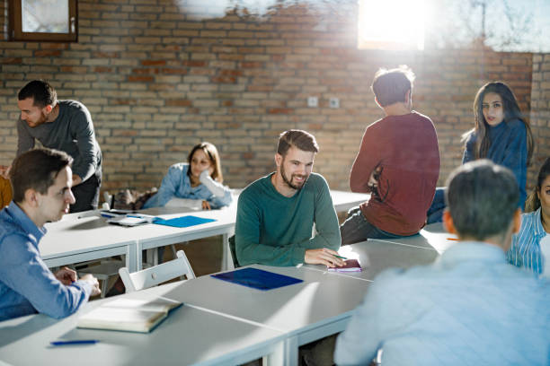 istock College students and teacher talking on a break in the classroom. 1460997298