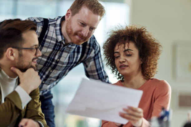 istock Young colleagues working on paperwork at casual office. 1460998834