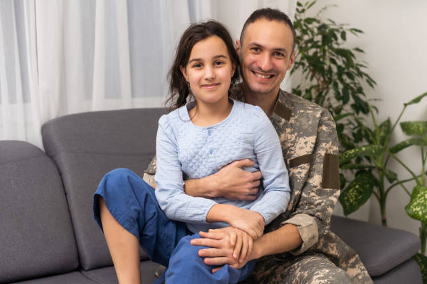 istock military father hugging his daughter. 1460998924