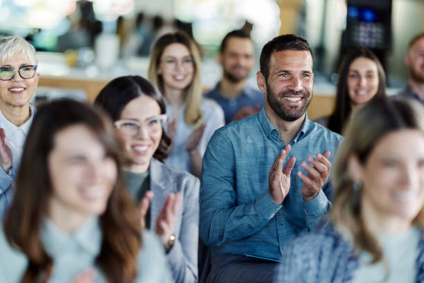 istock Happy entrepreneurs applauding on a seminar in board room. 1460999026
