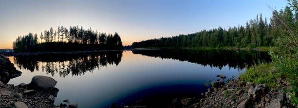 istock Panoramic view of a mirror lake in a dense forest on the sunset 1460999396