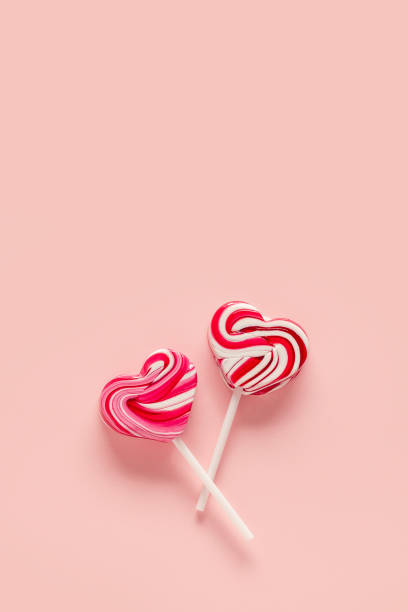 istock Heart shaped lollipops on a pink background. 1460999488