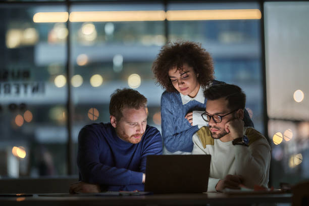 istock Business team working on a computer late in the office. 1460999924