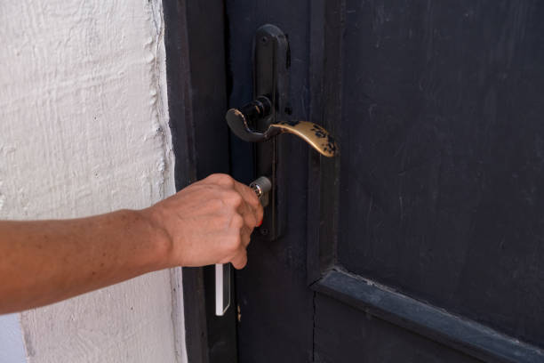 istock Woman's hand opening a house door 1461000455