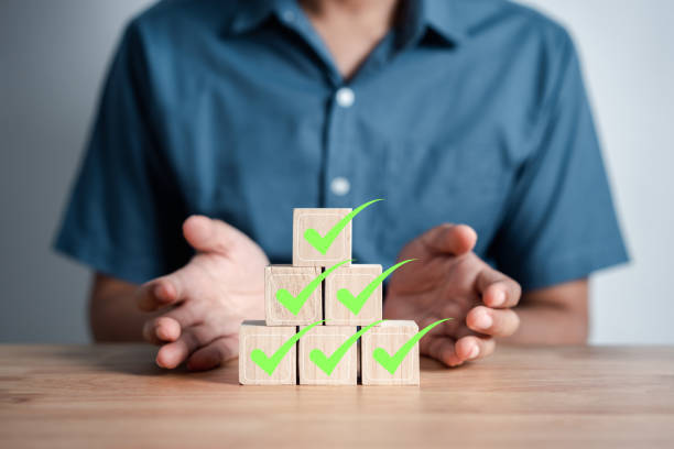 istock Businessman stacking green correct icon which on wooden block for document and project approve, check, mark. 1461001241