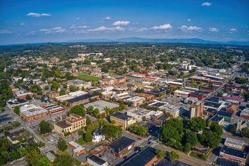 An aerial view of Downtown Cleveland, Tennessee with dense buildings under a blue sky with tiny clouds