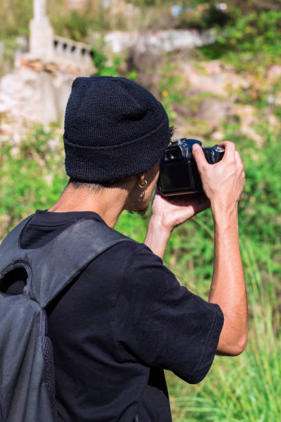 istock Young photographer in a wool hat makes a photo 1461002569