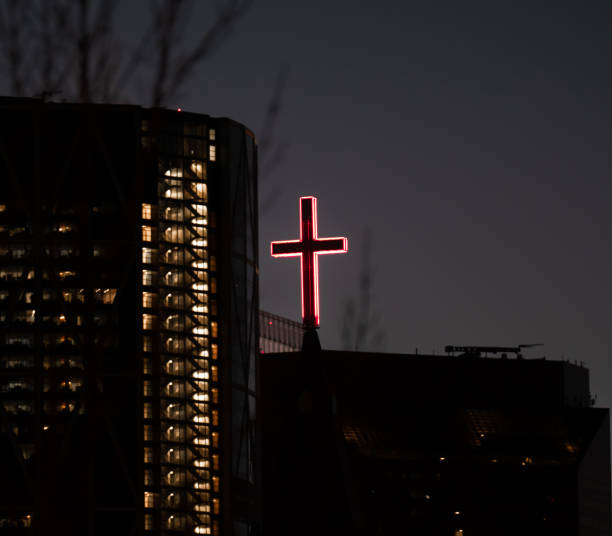 istock Red Cross lit up at night in the city 1461002611