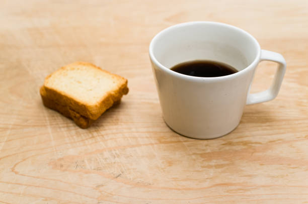 istock white stoneware cup with black coffee and rusks on a wooden tabl 1461003232