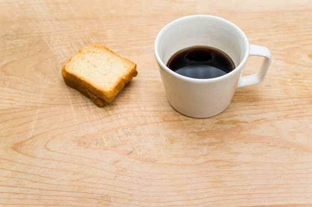 istock white stoneware cup with black coffee and rusks on a wooden tabl 1461003244