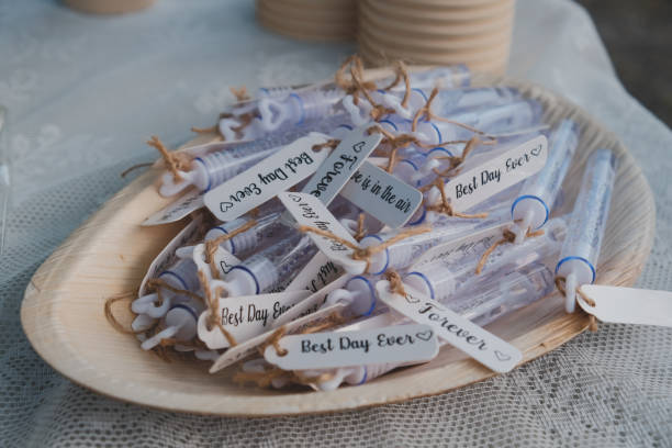 istock Labels with texts on wedding soap bubbles tubes in a wooden plate 1461003461
