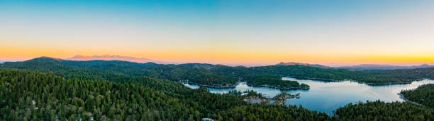 istock Panoramic view of a calm lake and forest landscape during a beautiful sunset 1461006967