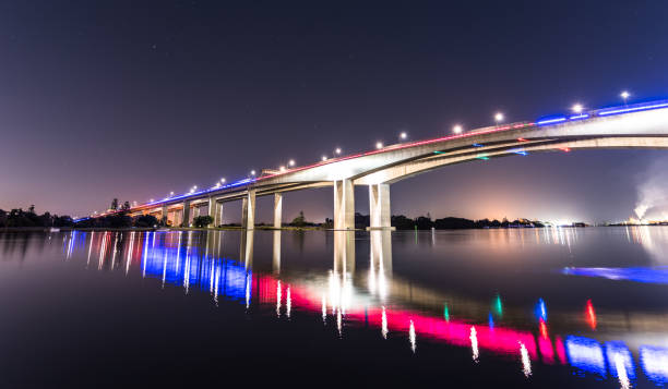 istock Night view of a large bridge over water with reflections 1461007590