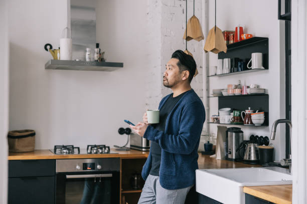 istock Japanese man having a cup of coffee at home 1461007870