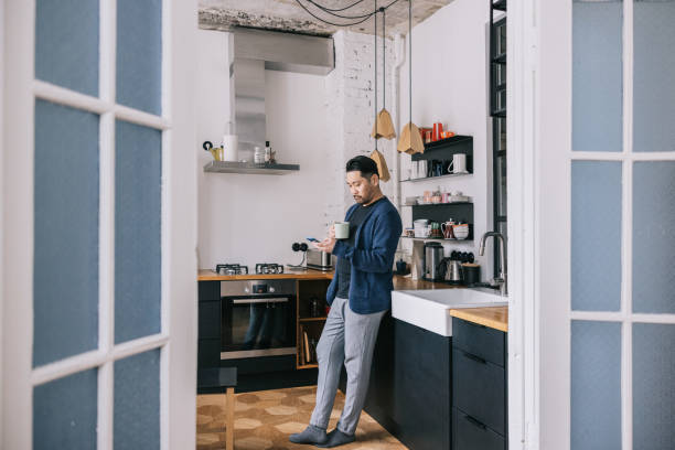 istock Japanese man having a cup of coffee at home 1461007887