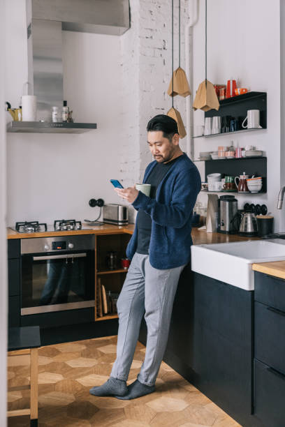 istock Japanese man having a cup of coffee at home 1461007893