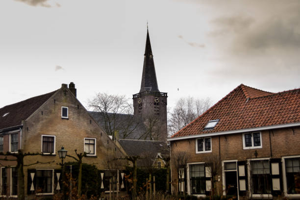 View of a tower among other buildings on a cloudy day