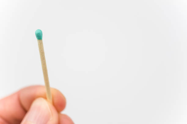 istock wooden match with blue head close up against a white background 1461008175