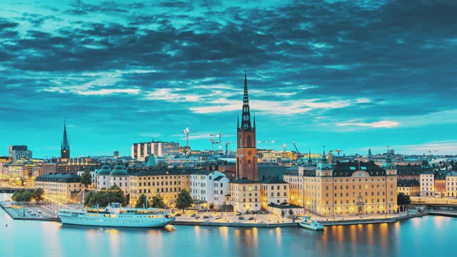 Stockholm, Sweden. Scenic View Of Stockholm Skyline At Summer Evening. Famous Popular Destination Scenic Place In Dusk Lights. Riddarholm Church In Day To Night Transition Time Lapse