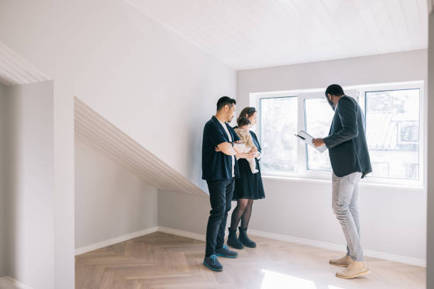 istock Real Estate AGent showing potential new home to clients 1461010119